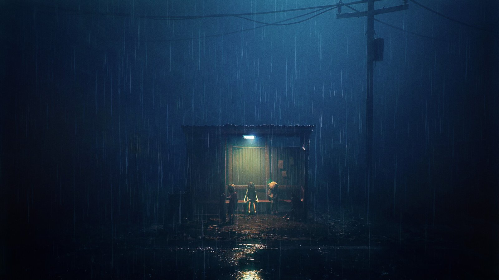Three children sit under a small shelter at night during heavy rain, lit by a single lamp.